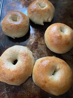 four bagels sitting on top of a baking sheet