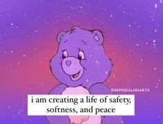 a purple teddy bear sitting on top of a table next to a sign that says i am creating a life of safety, softness, and peace