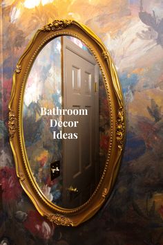 a mirror with the words bathroom decor ideas on it in front of a painted wall