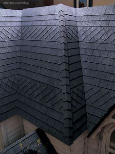 the roof of a building is made out of black shingles