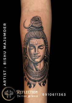 a tattoo on the arm of a woman with a buddha head in black and white