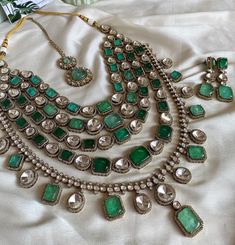 **Parineeti Wedding Set: Green Mint Mossanite Doublets Bridal Necklace Set** Elevate your bridal look with the Parineeti Wedding Set, a stunning green mint bridal necklace designed to captivate. This exquisite set features a mesmerizing array of mossanite doublets, which blend elegant green mint hues with the brilliant sparkle of mossanite. The necklace showcases a delicate, intricate design, perfect for adding a touch of sophistication and glamour to your wedding ensemble. With its luxurious craftsmanship and timeless appeal, this bridal necklace set is a flawless choice for your special day, ensuring you shine with grace and elegance. Green Bridal Jewellery Set Kundan, Mint Green Bridal Jewellery Set, Green Bridal Jewellery Set, Green Bridal Jewellery, Bridal Necklace Designs, Bridal Necklace Set, Green Mint, Bridal Look, Wedding Set