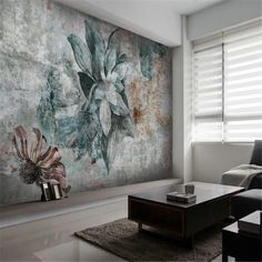 a living room filled with furniture and a large painting on the wall above it's coffee table