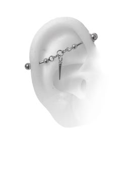 an ear with a chain attached to it and a piercing on the end of it