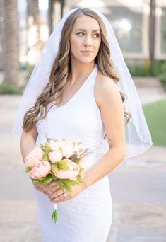 a woman in a wedding dress holding a bouquet