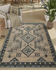 a living room with furniture and rugs on the floor