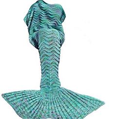 a woman wearing a blue knitted mermaid tail