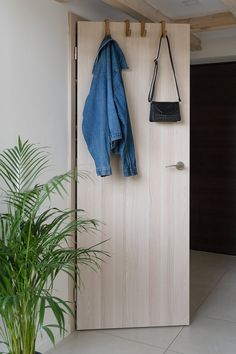 a wooden door with a coat hanging on it