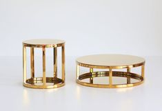 two round tables sitting next to each other on a white surface