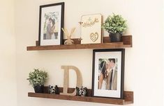 two wooden shelves with pictures and photos on them, one holding a couple's initials