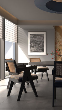 a dining room table with chairs and artwork on the wall