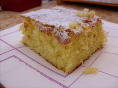 a close up of a piece of cake on a paper towel with some powdered sugar