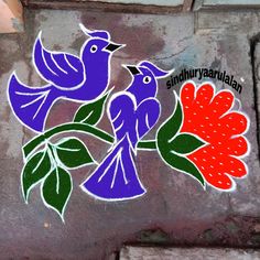 two colorful birds sitting on top of a brick wall next to a red and green flower