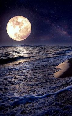 a full moon is seen over the ocean on a clear night with stars in the sky