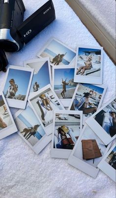 many polaroid photos are laying on a towel