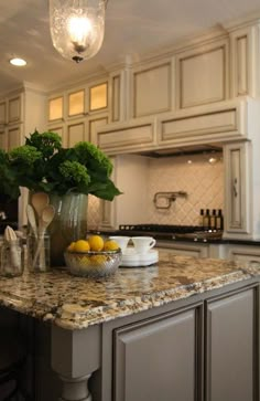 a kitchen with marble counter tops and an island in front of the stove top oven