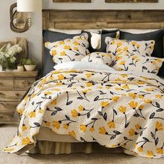 a bed with yellow and black flowers on it