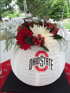 a paper lantern decorated with flowers and the word ohps state on it is sitting on a table