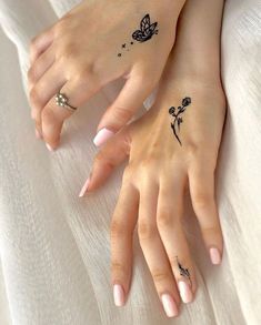 two women with matching tattoos on their hands