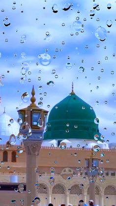 the dome of a building is covered with water droplets as people stand in front of it