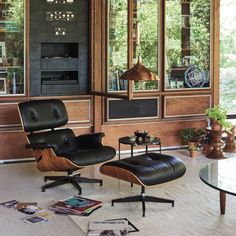 an eames chair and ottoman are in the living room