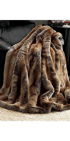 an animal fur blanket on the floor next to a chair