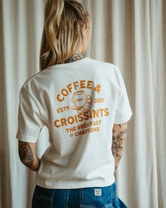 Coffee & Croissants White | Women's Graphic T-Shirts – P&Co USA French T Shirts Graphic Tees, Coffee Shop Tshirts, Staff Shirt Design, Cafe Tshirt Design, Merchandise Ideas Clothing, Coffee Shop T Shirt, Coffee Shop Merchandise, Tshirt Graphic Design Ideas, Coffee Shirt Ideas