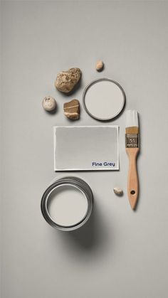 a paintbrush, brush, and some other items on a white surface with the word fine gray written in blue