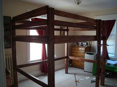 a bunk bed in a bedroom with red curtains