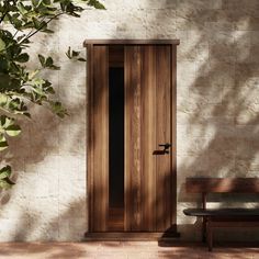 a wooden door sitting next to a bench on top of a brick floored building