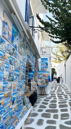 an alley way with many pictures on the wall