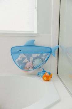 a bath tub with a fish net and toys in it