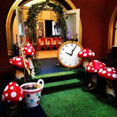 there is a clock in the center of this room with mushrooms and plants around it