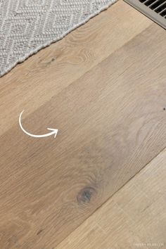 a close up of a wood floor with an arrow drawn on it