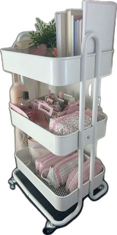 three tiered storage cart with books and other items on it's wheels,