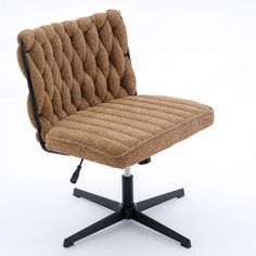 a brown chair sitting on top of a black metal base with an upholstered seat