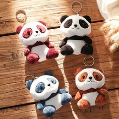 four panda keychains are sitting on a wooden table with the words, your style for less