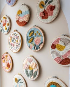 a bunch of embroiderys are hanging on the wall