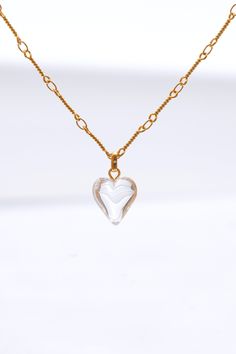 This stunning set features a beautifully crafted heart-shaped pendant adorned with shimmering crystal, hanging gracefully from a delicate gold chain. The matching earrings mirror the pendants' design, offering a perfect balance of sophistication and charm. Ideal for both everyday wear and special occasions, this set effortlessly enhances any outfit with a touch of timeless glamour. Handmade item 18k gold plated brass Syn crystal Hypoallergenic 925 silver post Necklace length: 42cm+6cm extension Elegant Gold Crystal Necklaces For Valentine's Day, Heart-shaped Crystal Jewelry With Adjustable Chain, Heart Shaped Crystal Jewelry With Adjustable Chain, Clear Heart Pendant Jewelry As Gift, Clear Heart Pendant Jewelry Gift, Elegant Gold Heart Pendant Crystal Necklace, Gold Double Heart Crystal Jewelry, Gold Crystal Heart Necklace For Anniversary, Gold Crystal Heart Pendant Jewelry