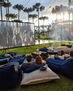 people sitting on bean bags in front of a movie screen