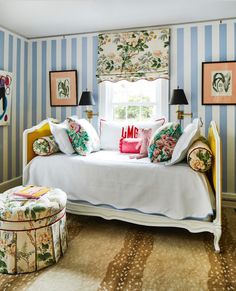 a bedroom with blue and white striped walls