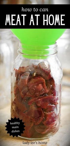 a jar filled with meat sitting on top of a table