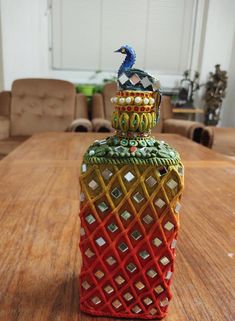 a decorative bottle sitting on top of a wooden table