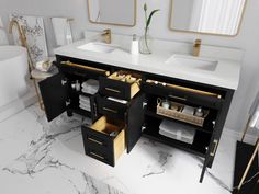 a bathroom with marble counter tops and black cabinetry, along with gold accents on the mirror