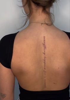 the back of a woman's neck with writing on her left shoulder and lower back