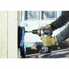 a person using a power drill on a wall