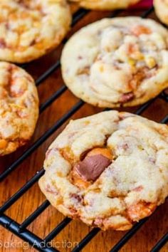 chocolate chip cookies cooling on a rack with other cookies in the backgroung