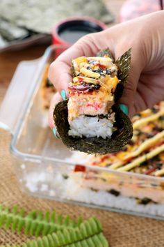 someone is holding some sushi in their hand and they are ready to eat it