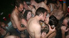 a group of people in a bath tub drinking beer