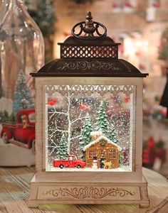 a lit up christmas lantern on top of a table